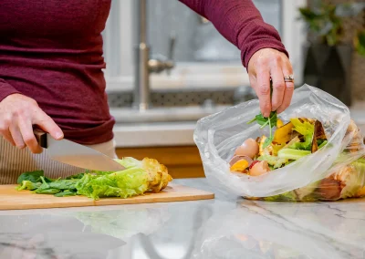 Putting-Food-Scraps-in-Food-Waste-Bag-EJ-Harrison-Industries-Trash-Hauler-Ventura-County