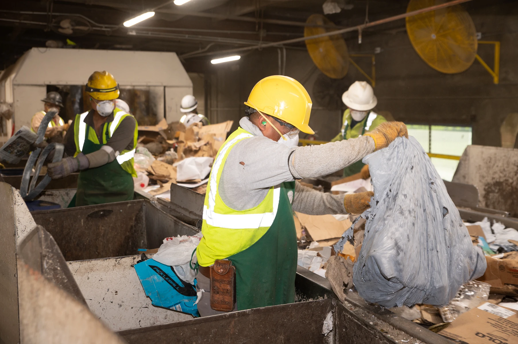 Gold Coast Recycling sorter removes plastic bag from picking line.